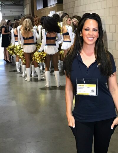 Chiropractor Dr Mindy Mar with Charger Girls in hallway on game day