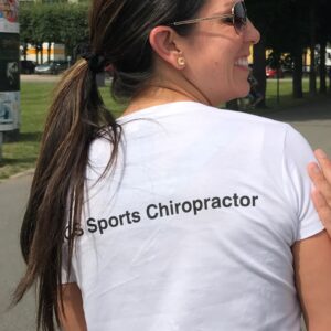 Dr Mindy Mar wearing a white sports chiropractor t-shirt